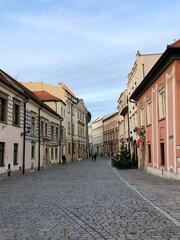 Fototapeta na wymiar Cobblestone Street with Buildings Either Side in Krakow Old Town, Poland, Europe 