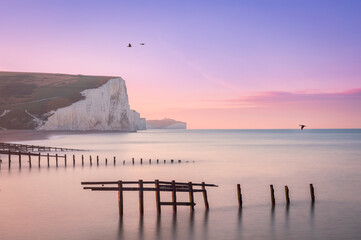 High tide lilac sky sunrise at Cuckmere Haven and the Seven Sisters cliffs on the east Sussex coast...