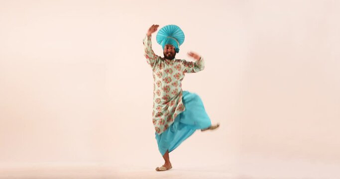 Sikh man doing bhangra dance during Baisakhi celebration