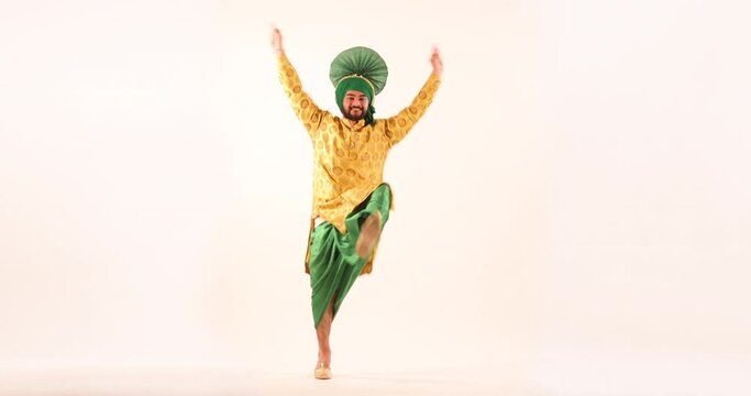 Sikh man doing bhangra dance during Baisakhi celebration