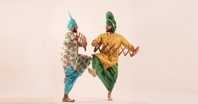 Sikh men performing bhangra with sapp during Baisakhi Celebration
