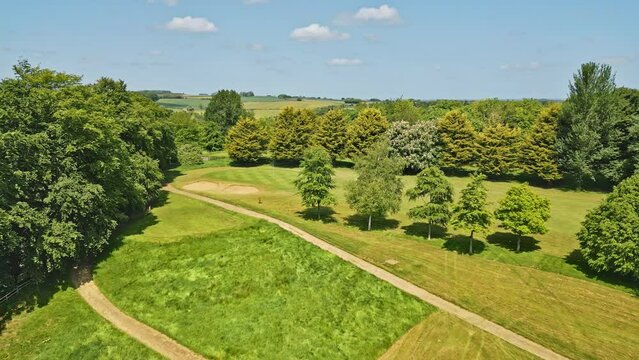 Drone captures UK park. Folks enjoy meandering stream, lovely picnic spots. Wooded charm: Hubbard's Hills, near Louth, Lincolnshire.