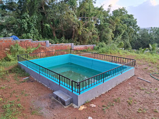 A swimming pool located in landscape with water