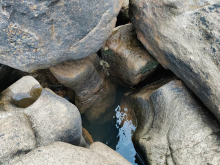 Small Pond surrounded by rocks closeup shot