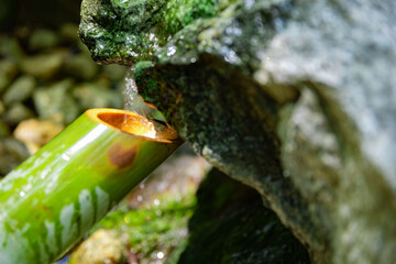 A Japanese Bamboo Water Fountain Shishi-Odoshi in Zen Garden close up