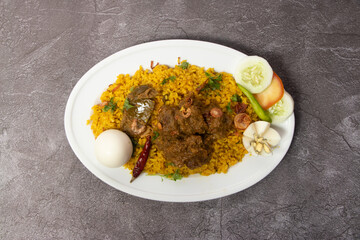 Beef Bhuna Khichuri, biryani, pulao, rice with boiled egg and salad served in dish isolated on background top view of bangladesh food