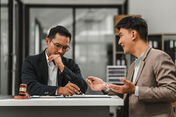 Two disgusting businessmen Asian lawyer of Indian descent paying attention to mistakes, proposing corrections. Businessman discussing contract policy terms with client, rights of liberty concept.
