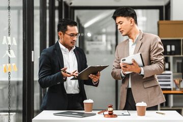 Two disgusting businessmen Asian lawyer of Indian descent paying attention to mistakes, proposing...