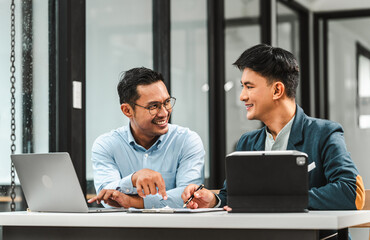 Serious young business asian man supervisor analyse financial report of responsible worker pay attention on mistakes propose correction. insurance agent legal obligations, policy terms conditions