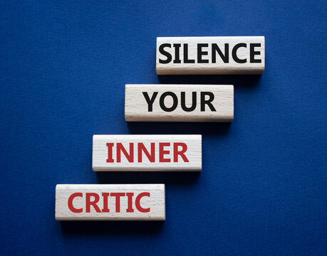 Silence your inner critic symbol. Wooden blocks with words Silence your inner critic. Beautiful deep blue background. Business and Silence your inner critic concept. Copy space.