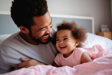 Happy loving young Black dad holding adorable mixed race baby daughter having fun in bed at home. Smiling African father playing with cute funny infant child girl waking up in bedroom in the morning - Powered by Adobe