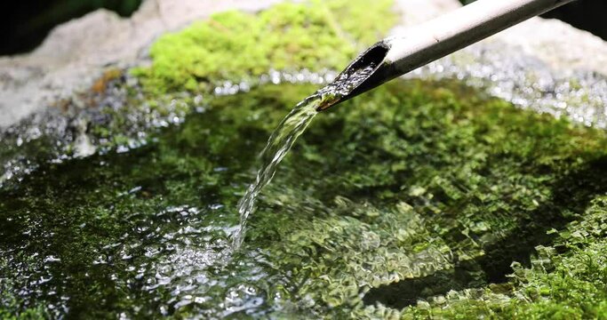 A slow motion of Japanese Bamboo Water Fountain Shishi-Odoshi in Zen Garden