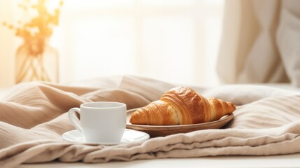 Fototapeta na wymiar Close up breakfast tray with coffee and croissant on the bed.