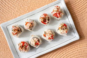 sushi is a Japanese dish of prepared vinegared rice, usually with some sugar and salt, accompanied by a variety of ingredients such as seafood, often raw and vegetables.