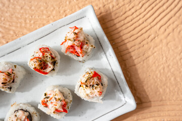 sushi is a Japanese dish of prepared vinegared rice, usually with some sugar and salt, accompanied by a variety of ingredients such as seafood, often raw and vegetables.