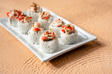 sushi is a Japanese dish of prepared vinegared rice, usually with some sugar and salt, accompanied by a variety of ingredients such as seafood, often raw and vegetables.