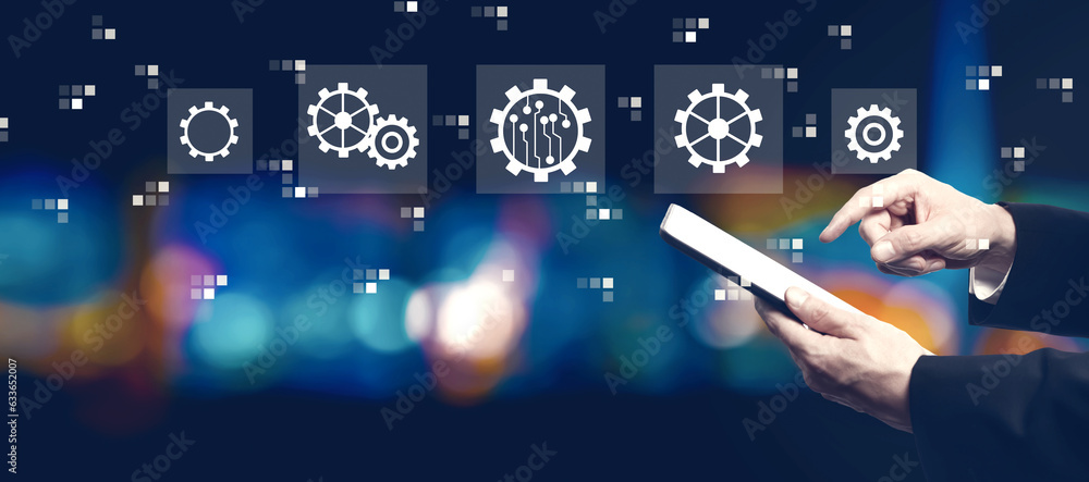 Poster automation concept with businessman using a tablet computer at night