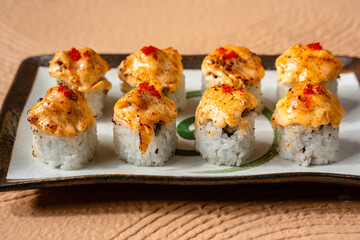 sushi is a Japanese dish of prepared vinegared rice, usually with some sugar and salt, accompanied by a variety of ingredients such as seafood, often raw and vegetables.