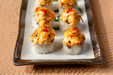 sushi is a Japanese dish of prepared vinegared rice, usually with some sugar and salt, accompanied by a variety of ingredients such as seafood, often raw and vegetables.