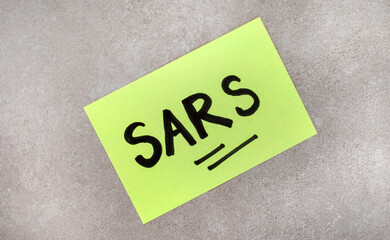 South African Revenue service SARS written on post-it with grey background