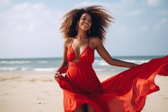 Black American Attractive woman in red dress dancing on the beach