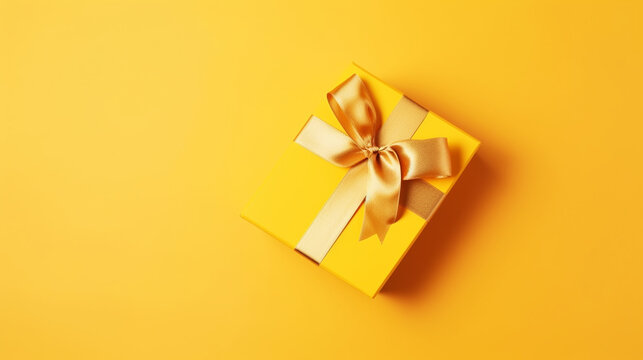 Premium Photo  Black gift with a beige ribbon on a yellow background. view  from above.