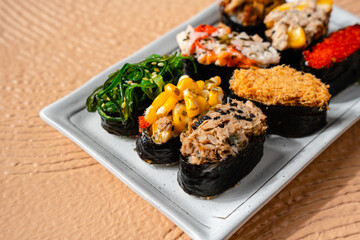 sushi is a Japanese dish of prepared vinegared rice, usually with some sugar and salt, accompanied by a variety of ingredients such as seafood, often raw and vegetables.