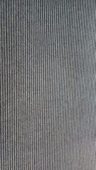 A close up of a wall with a textured fabric
