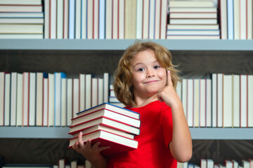 School kid with pile of books. Children enjoying book story in school library. Kids imagination, interest to literature. Kids smart activity. Child study read book in classroom.