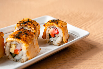 sushi is a Japanese dish of prepared vinegared rice, usually with some sugar and salt, accompanied by a variety of ingredients such as seafood, often raw and vegetables.