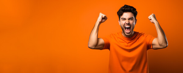 American football fan celebrating a victory on orange background with empty space for text 