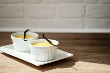 Homemade vanilla custard on wooden table. Copy space