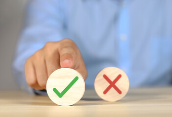 Businessmen think and choose between right and wrong symbols. True and False symbols accept...
