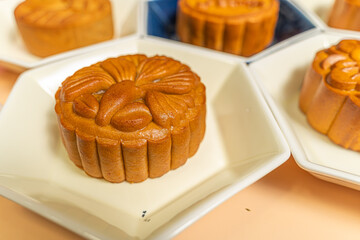 a tasty round moon cake at mid autumn festival. Food and drink on sweet beige background.