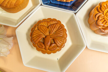 a tasty round moon cake at mid autumn festival. Food and drink on sweet beige background.