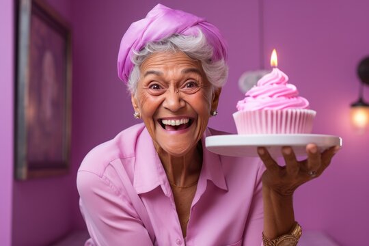 Happy Old Woman With Purple Hair With Cake Pastel Pink Background. Old Woman, Purple Hair, Cake, Pastel Pink Background, Happiness, Aging, Celebration, Style