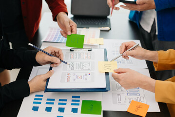  UX developer and ui designer brainstorming about mobile app interface wireframe design with...