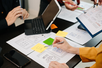 Obraz premium UX graphic designer planning application process development prototype wireframe for web smart phone. Creative digital development agency..