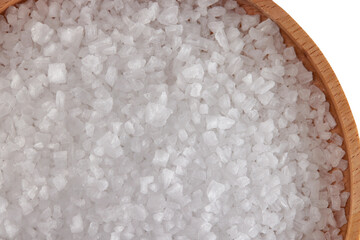 Macro image of sea salt crystals on wooden tray board isolated at white background.
