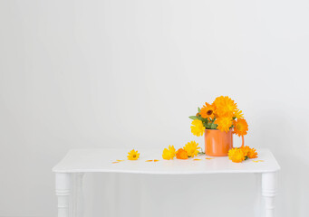 bouquet with orange marigolds   in cup    on white  background