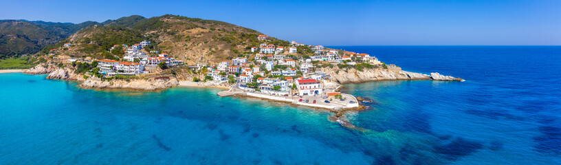 Lovely greek fishing village of Armenistis in a quiet summer morning. Port with local beach in transparent clear water at Ikaria, Greece - obrazy, fototapety, plakaty