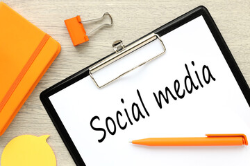 text on white paper on black folder. wooden background. text on paper. Social Media