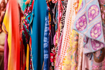 Multicolored clothes and fabrics in an arabic market - 633679416