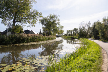 Fototapeta na wymiar River Het Gein, flows through the Dutch landscape near the rural village of Abcoude.