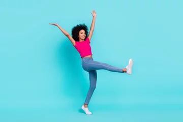 Deurstickers Dansschool Full body portrait of excited cheerful girl raise hands dancing step walk enjoy free time isolated on turquoise color background