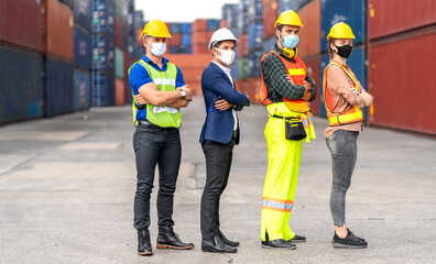 Professional engineer container cargo foreman team in helmets working standing and using walkie talkie checking stock into container for loading.logistic transport and business industry export