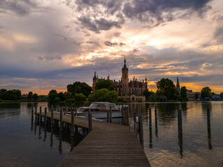 Schloss Schwerin im Abendlicht mit Steg und Boot