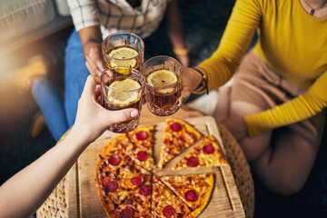 Group hands, toast cocktail and pizza in home with celebration, party and closeup for alcohol, glass or juice. Friends, together and eating for event, culture or relax with success in lounge at house
