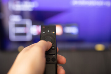 Tv online. Television streaming video. Media TV on demand. Online Multimedia video concept on TV set. Watching online TV with modern remote control in hand.
