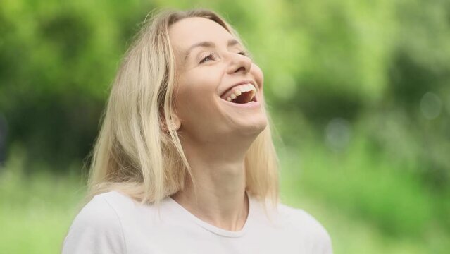 Close up portrait of smiling carefree young blond woman feeling absolutely happy and satisfied enjoying great day at green park Self confidence female looking ahead feel proud achievement outdoors